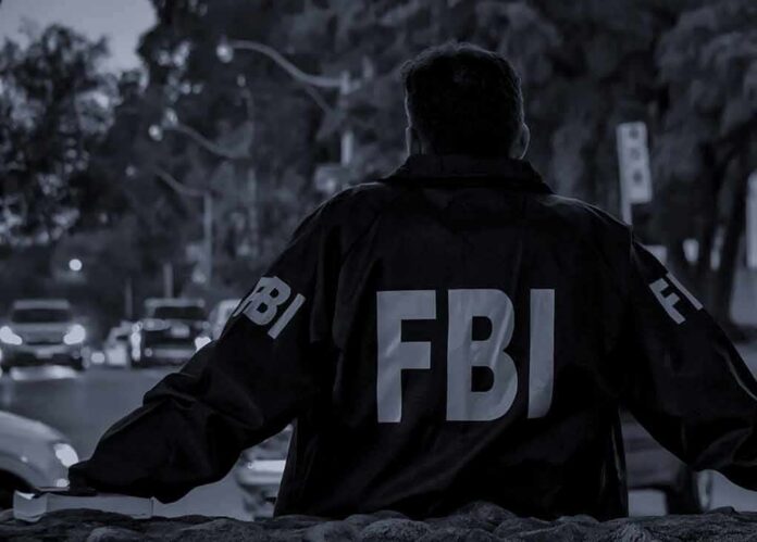 FBI agent in jacket facing a city street at dusk