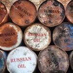 Rusty oil barrels stacked in rows