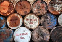 Fuel Shock: China Drives Russian Oil Spike Rusty oil barrels stacked in rows
