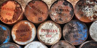 Rusty oil barrels stacked in rows