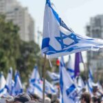 Israeli flags waved at a street demonstration
