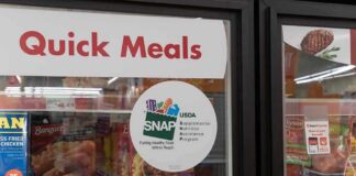 Grocery freezer door labeled Quick Meals with SNAP program sticker
