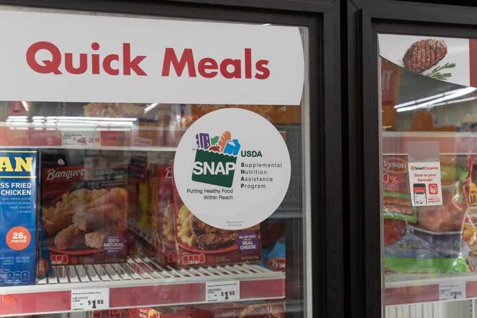 shutterstock_2330109127 Grocery freezer door labeled Quick Meals with SNAP program sticker