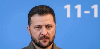 UN Shock: Zelensky Triggers Seoul Backlash man in olive shirt against blue background