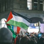 Band Banned Over Palestinian Flag Display Palestinian flag waved at a nighttime street protest