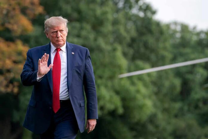 shutterstock_2589906687 Donald Trump walking outdoors and waving