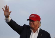 Secret Service Missed 102 Red Flags man in a red baseball cap waving