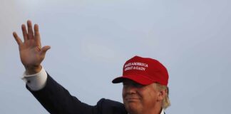 Secret Service Missed 102 Red Flags man in a red baseball cap waving