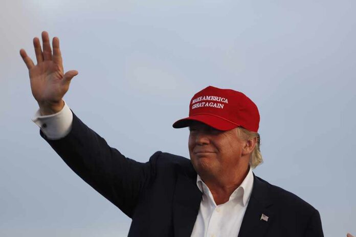 man in a red baseball cap waving