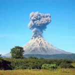 Volcano erupting with a towering ash plume
