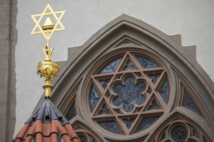 shutterstock_785815858 Star of David atop synagogue roof with stained glass window