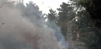 Burning vehicle on a smoke-filled street