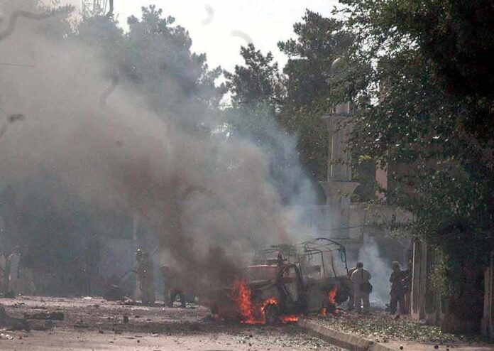 Burning vehicle on a smoke-filled street