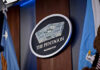 Historic First: Military Execution Returns The Pentagon emblem between two flags.