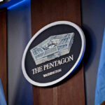 Historic First: Military Execution Returns The Pentagon emblem between two flags.