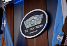Historic First: Military Execution Returns The Pentagon emblem between two flags.