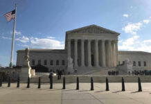 Supreme Court Signal Ups the Stakes Supreme Court building with flag and people outside.