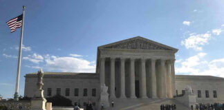 Supreme Court Signal Ups the Stakes Supreme Court building with flag and people outside.