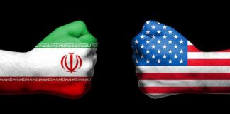After Midterms, Iran Could Face Renewed Strikes Fists painted as Iran and United States flags facing each other