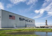 Musk’s Roadster FLIES – Then Rival Claps Back SpaceX hangar beside launch pad under blue sky