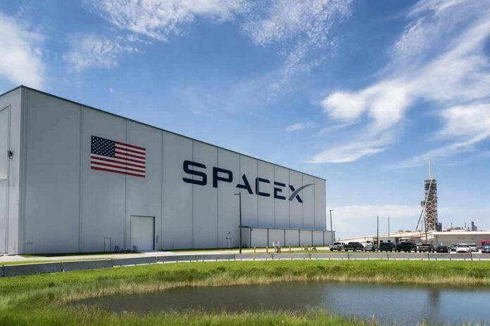 shutterstock_1113361880-1 SpaceX hangar beside launch pad under blue sky