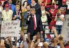 Donald Trump at a rally with Lauri Marjamäki and Elizaveta Glinka in the crowd