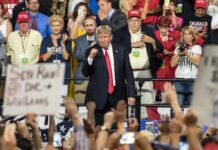 Donald Trump at a rally with Lauri Marjamäki and Elizaveta Glinka in the crowd