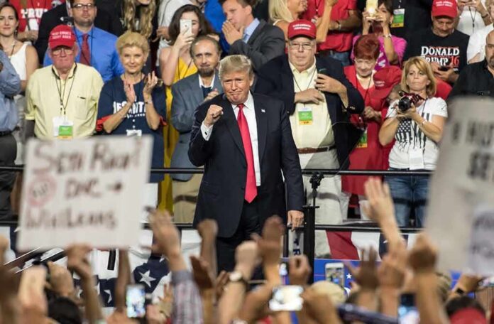 shutterstock_1147142282-1 Donald Trump at a rally with Lauri Marjamäki and Elizaveta Glinka in the crowd