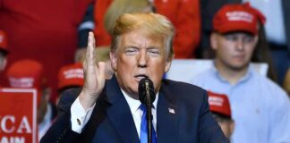 Trump Takes Aim At Three Major Fronts Donald Trump speaking at a rally with supporters in the background