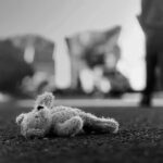 Surrogacy Mansion Horror Unleashed Stuffed toy lying on pavement in black and white