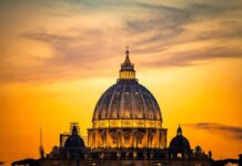 Rome Braces: Pope Heads To OR St. Peter's Basilica dome at sunset