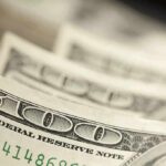 Trump-Branded Checks Hit 30 States Stack of U.S. hundred dollar bills in close-up