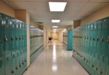 School Cover-Up Explodes In Virginia School hallway with rows of teal lockers