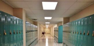 School Cover-Up Explodes In Virginia School hallway with rows of teal lockers