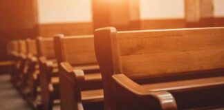 Wooden church pews in warm sunlight
