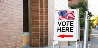 Court’s Hard Line Freezes Student Voting Sidewalk sign with American flag directing to a polling place