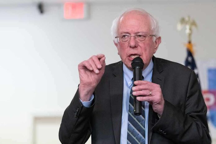 Bernie Sanders speaking into a microphone at an indoor event