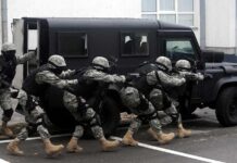 A Deadly Strike Raises Alarming Questions Tactical team advances beside an armored vehicle