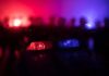 Downtown Blast Stuns Food Titan Police car light bar flashing red and blue at night