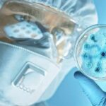 Mystery Pneumonia Triggers Mass Quarantine Scientist in protective gear examining a petri dish