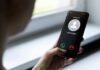 Voice Doppelgängers Demand Ransom Person holding smartphone with unknown caller screen