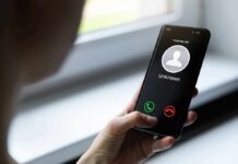 Voice Doppelgängers Demand Ransom Person holding smartphone with unknown caller screen