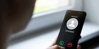Person holding smartphone with unknown caller screen