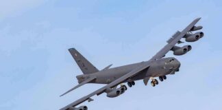 Military bomber aircraft banking in flight