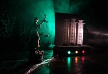 Two Lethal Doses Fail To Kill Death Row Inmate Lady Justice statue beside medical syringes with moody green light