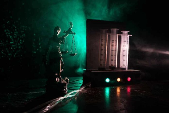 Lady Justice statue beside medical syringes with moody green light
