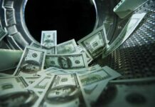 $74M Tax Grab Exposes IRS Weak Spot US dollar bills inside a washing machine drum