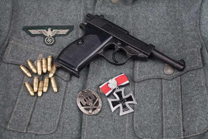 shutterstock_1711858141 Pistol on military jacket with ammunition and medals