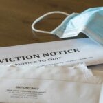 87-Year-Old Eviction Victim Dies In Madrid Eviction notice and torn envelope beside blue surgical masks