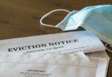 87-Year-Old Eviction Victim Dies In Madrid Eviction notice and torn envelope beside blue surgical masks